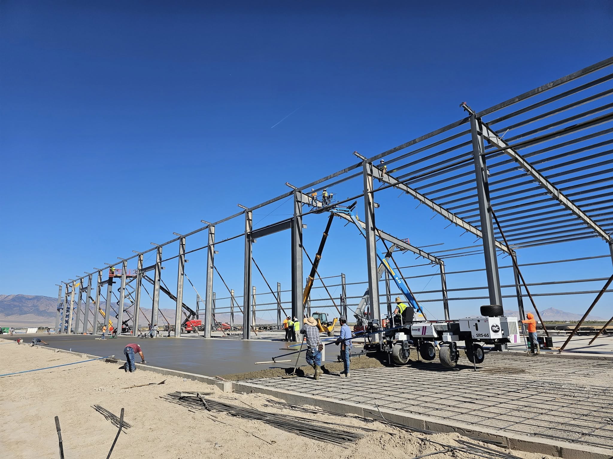 Commercial concrete construction project with steel framework and foundation work